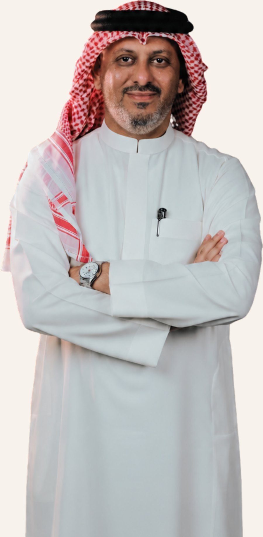 Mohamed J Shareeda, arms folded, in a white thobe and red-and-white shemagh.
